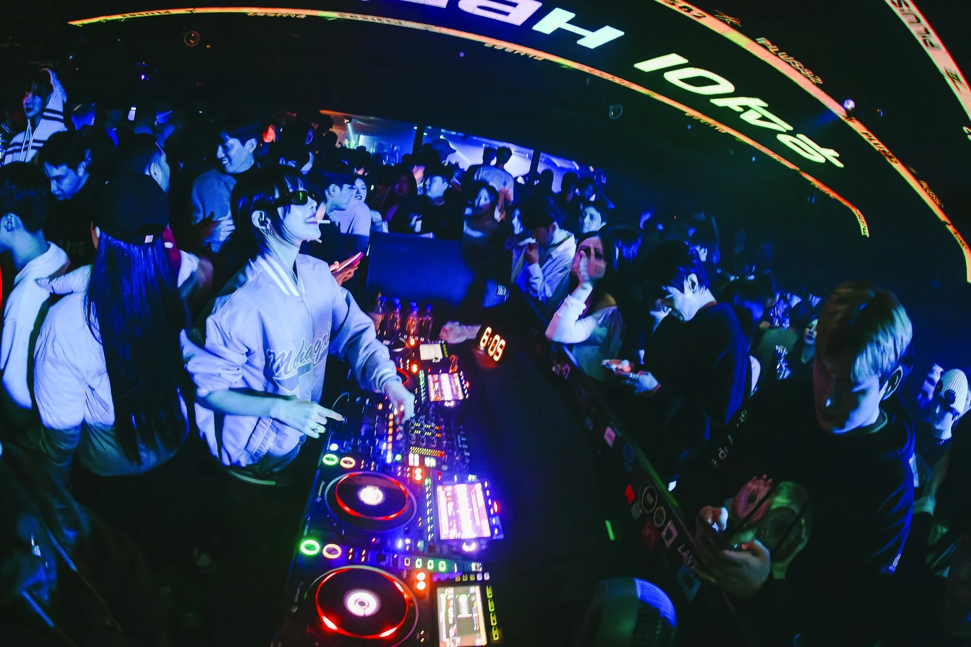YOONI mixing at the decks with the crowd around her